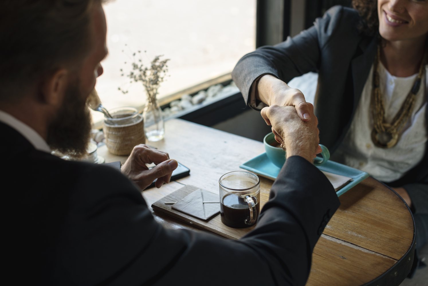 Business partners shaking hands during a meeting